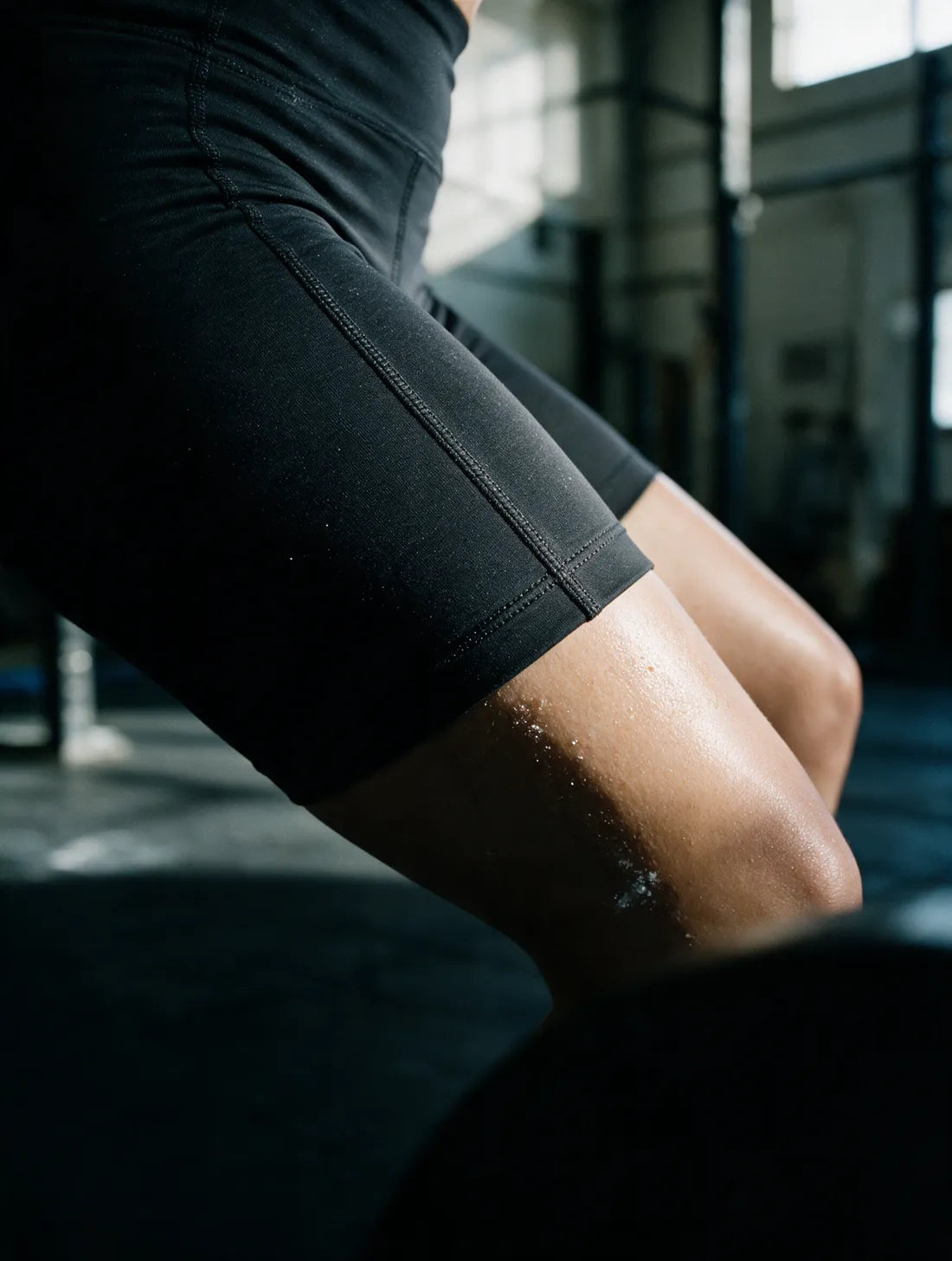 Close detail of the contoured panel seam running down the outside of a bent thigh, the seam flat and unbroken.